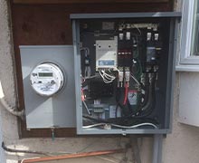 The home generator transfer switch installed neatly on the side of a residence
