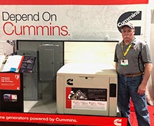 Ken Kloster in front of the Cummins Power Systems display table at the Timonium builder show