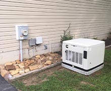 A Cummins RS17A air cooled residential generator installed on the side of a home