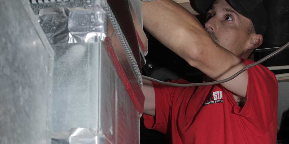 Heating and Air Conditioning Technician servicing a furnace