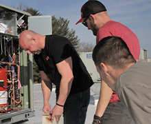 Three Five Star Power Systems heating and air conditioning techs working to install a new roof top unit