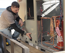 A Five Star Power Systems technician examining a unit before it is hoisted up and installed on top of a roof in Millersville, MD